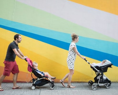 Expat family of four in front of a colourful wall in Hong Kong