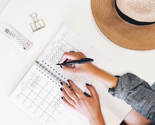 Girl writing on her planner